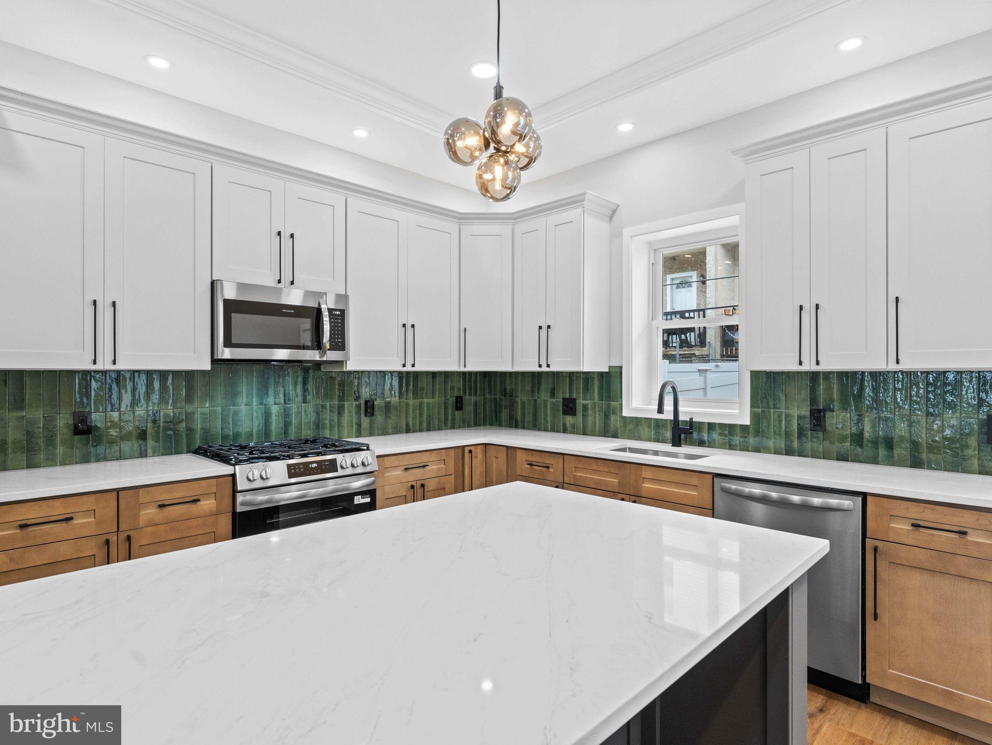 138 West Sharpnack Street Philadelphia, PA 19119 - Photo 15 of 44 a kitchen with stainless steel appliances granite countertop a sink and white cabinets