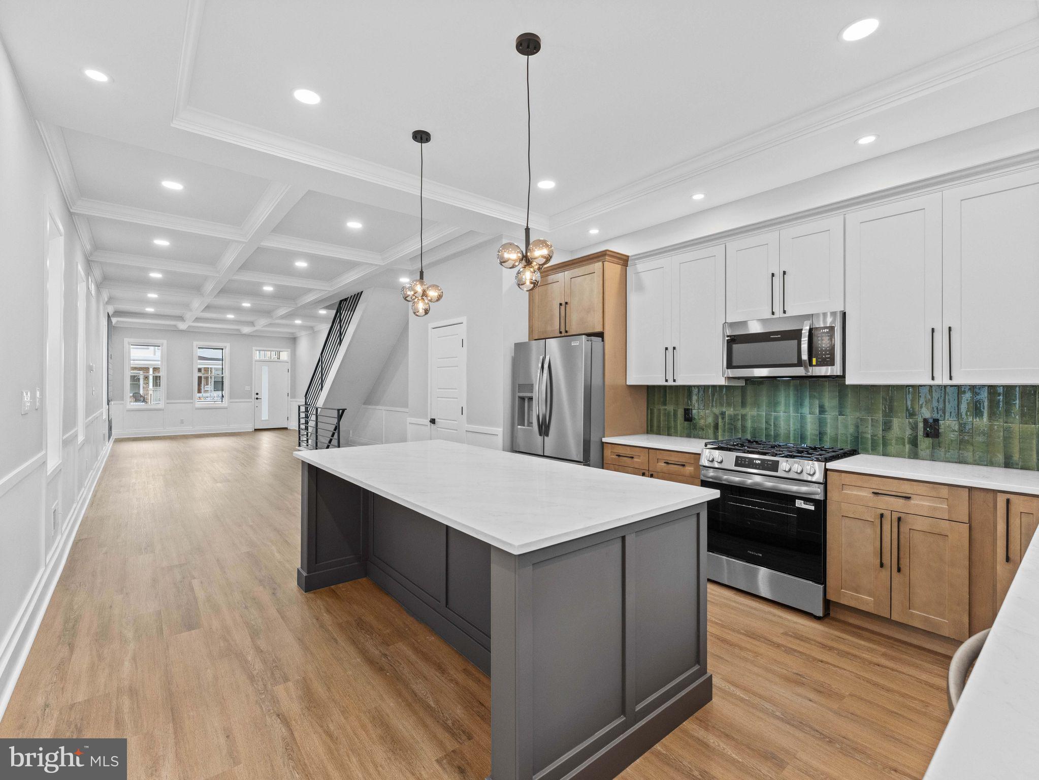 138 West Sharpnack Street Philadelphia, PA 19119 - Photo 18 of 44 a large kitchen with stainless steel appliances kitchen island a large island in the center
