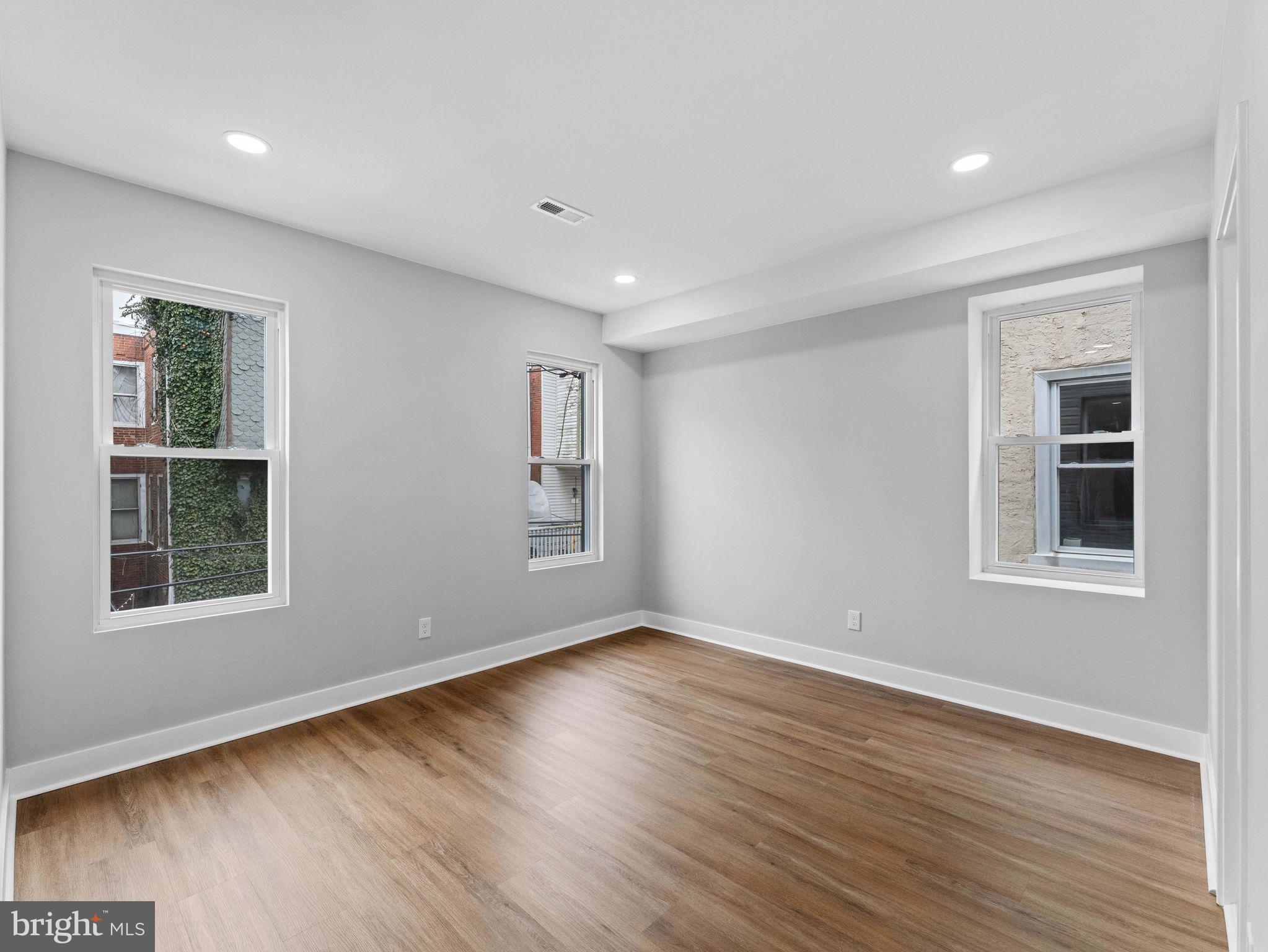 138 West Sharpnack Street Philadelphia, PA 19119 - Photo 26 of 44 a view of empty room with wooden floor and fan