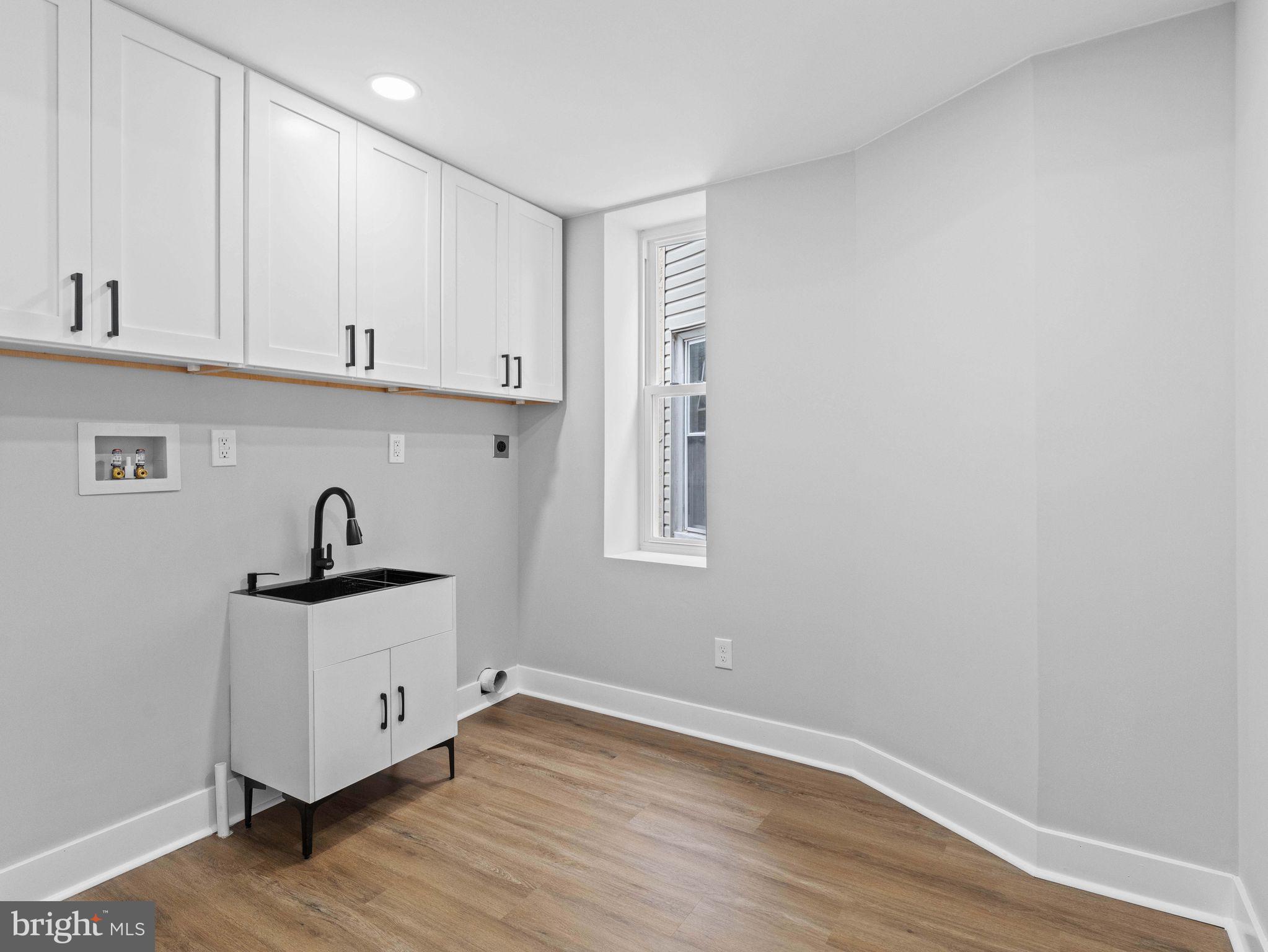 138 West Sharpnack Street Philadelphia, PA 19119 - Photo 30 of 44 a kitchen with granite countertop a sink and a stove top oven