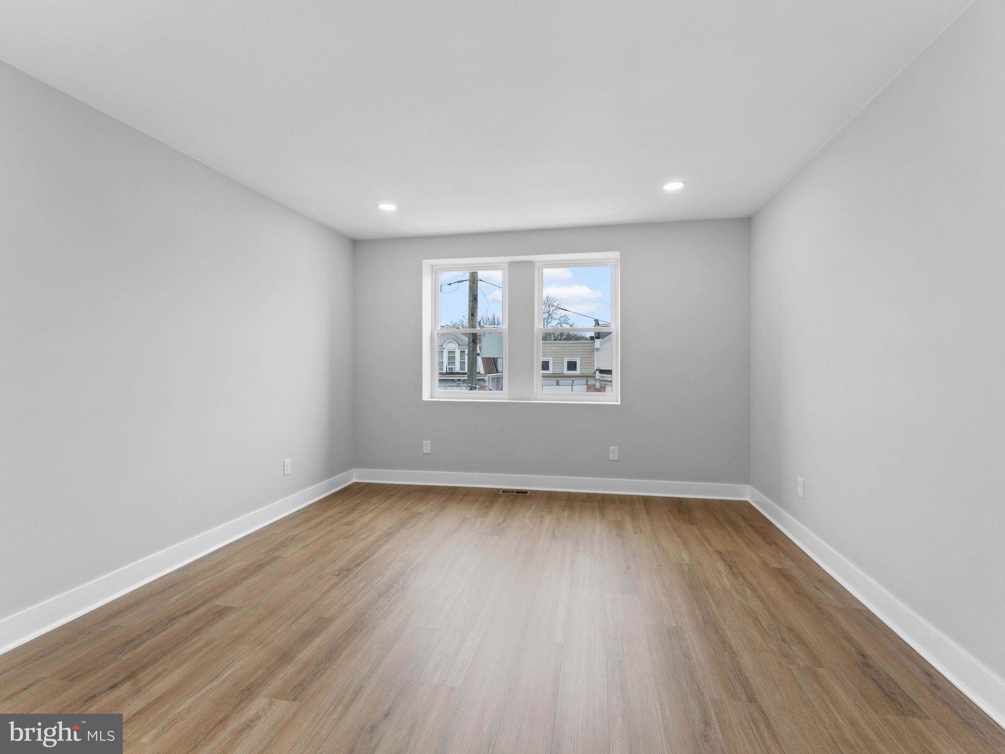 138 West Sharpnack Street Philadelphia, PA 19119 - Photo 31 of 44 an empty room with wooden floor and windows