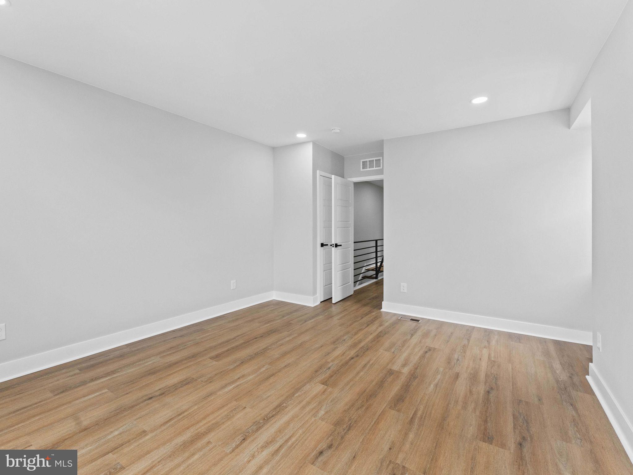 138 West Sharpnack Street Philadelphia, PA 19119 - Photo 32 of 44 a view of an empty room with wooden floor