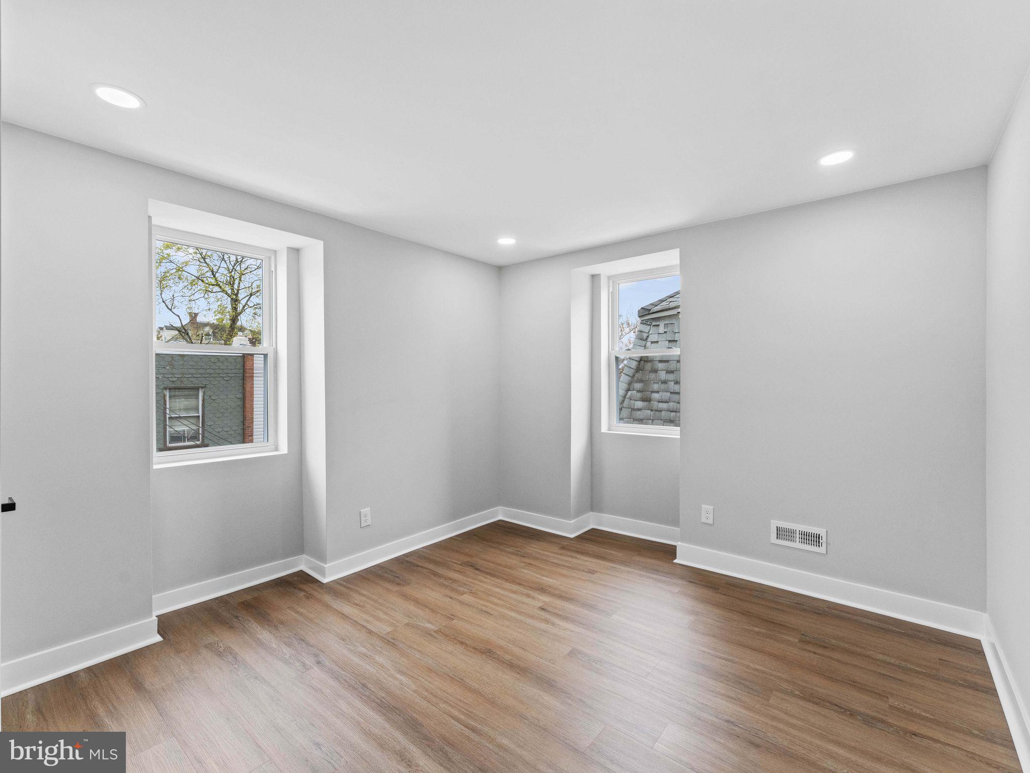 138 West Sharpnack Street Philadelphia, PA 19119 - Photo 33 of 44 a view of an empty room with wooden floor and a window