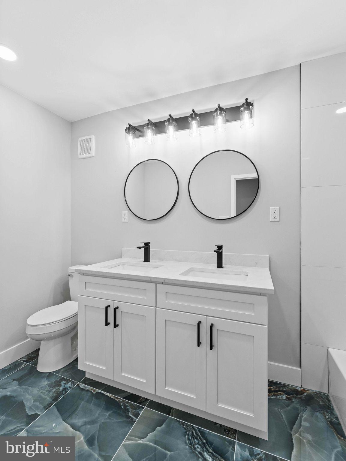 138 West Sharpnack Street Philadelphia, PA 19119 - Photo 37 of 44 a bathroom with a toilet sink and mirror