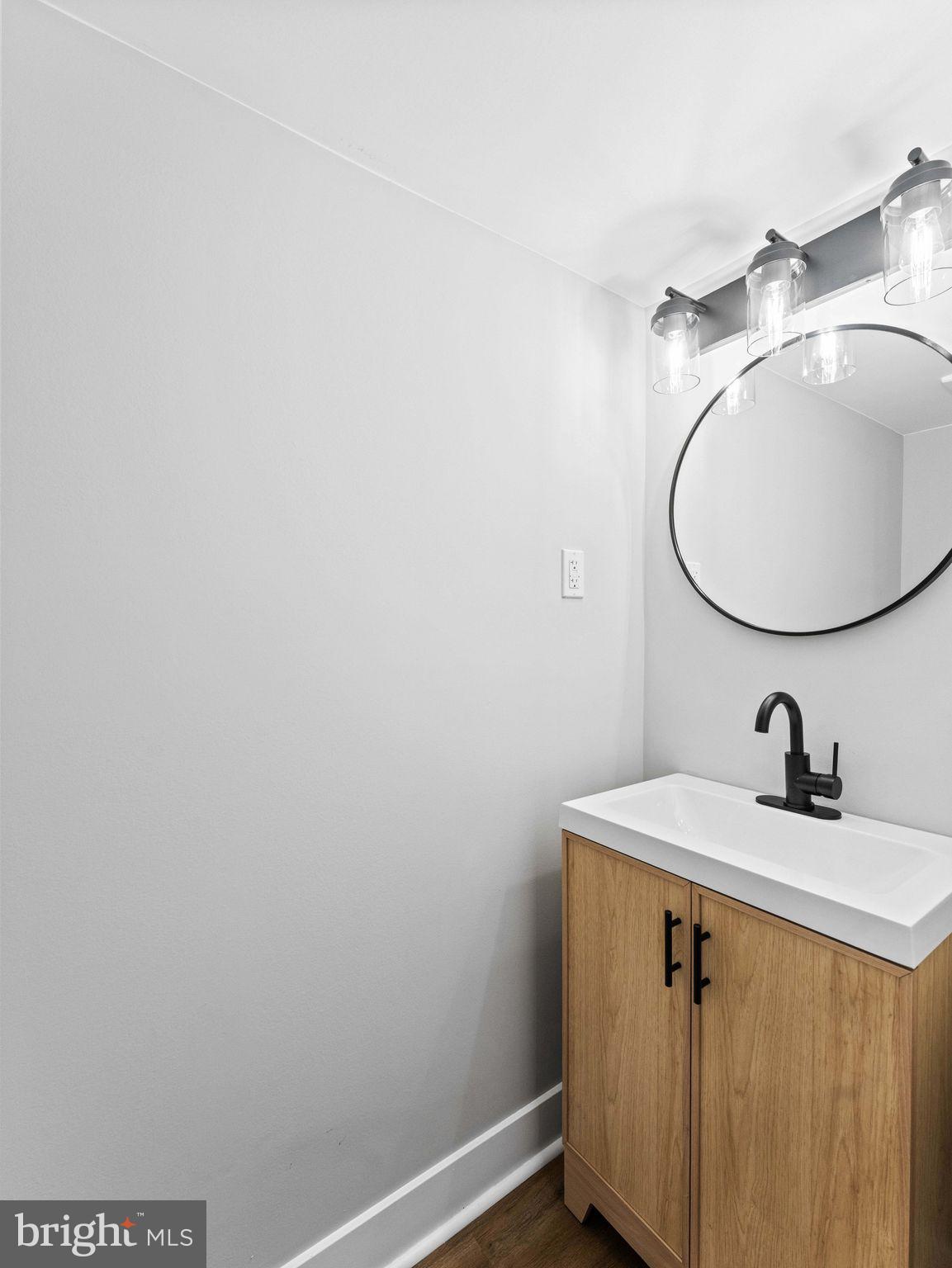 138 West Sharpnack Street Philadelphia, PA 19119 - Photo 42 of 44 a bathroom with a sink and mirror