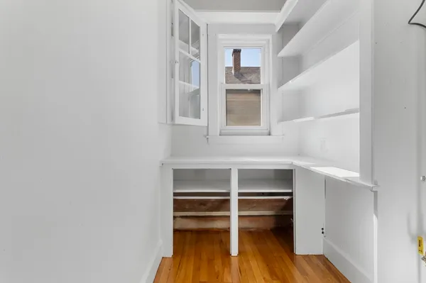 a view of walk in closet with empty racks