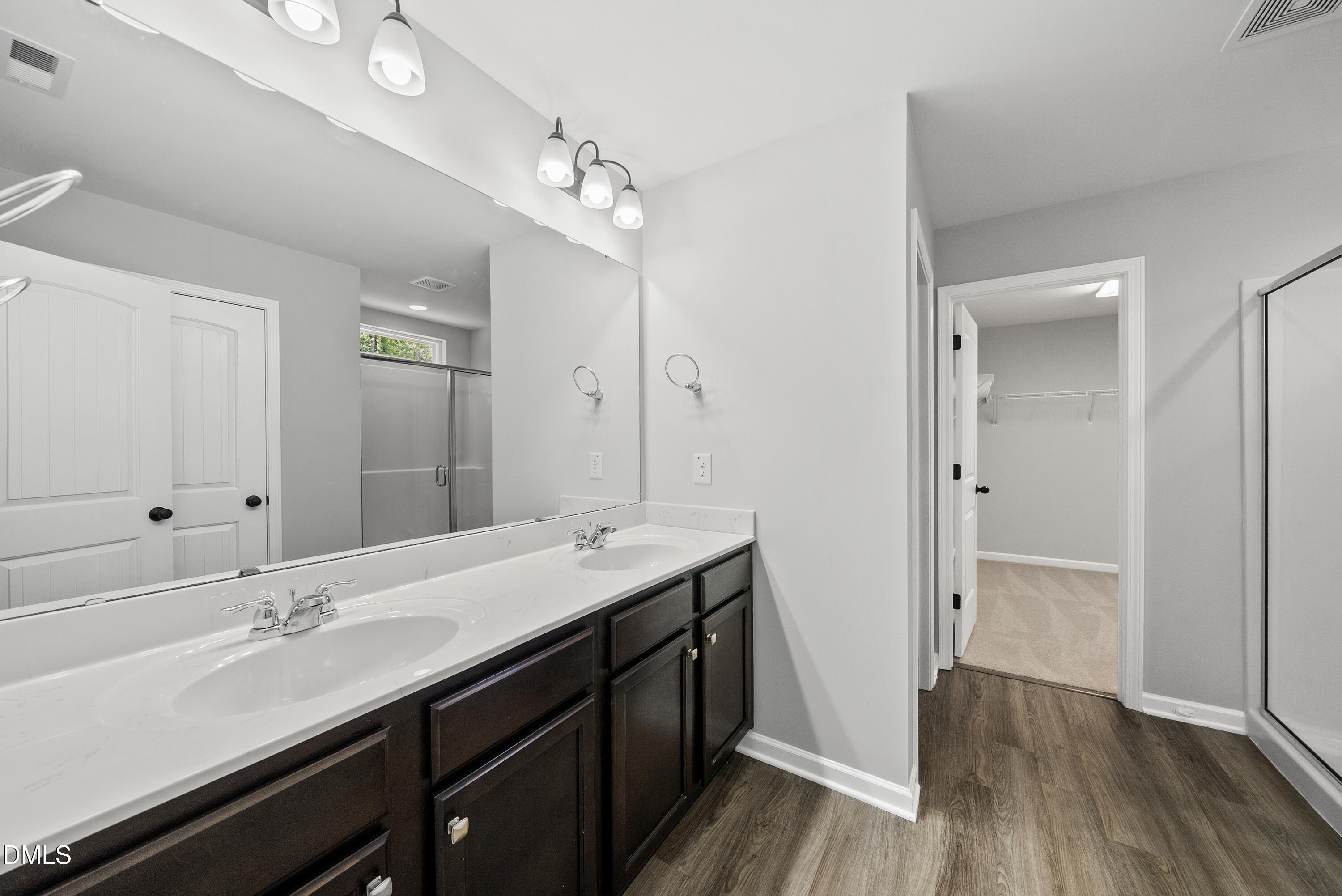 2816 Elsa Drive Raleigh, NC 27610 - Photo 26 of 35 a bathroom with a double vanity sink a mirror and a shower