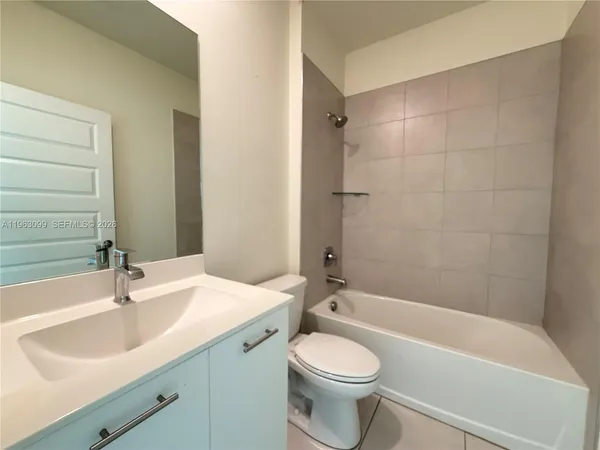 a bathroom with a sink a toilet and bathtub