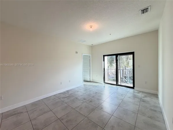 a view of an empty room with a window