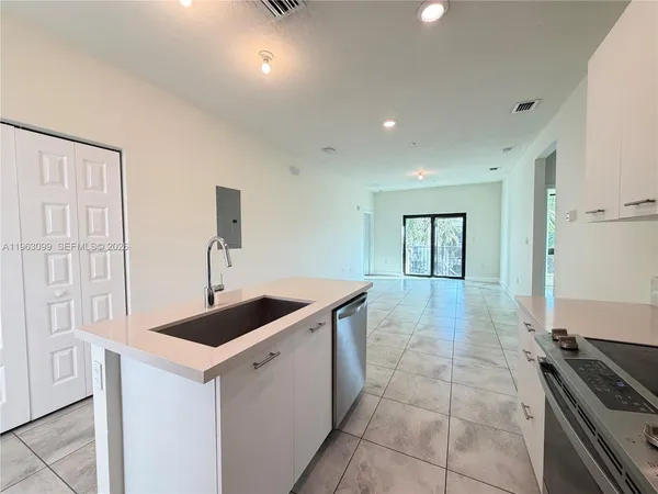 a kitchen that has a sink and a stove