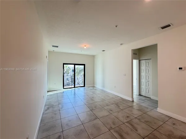 a view of an empty room with a window