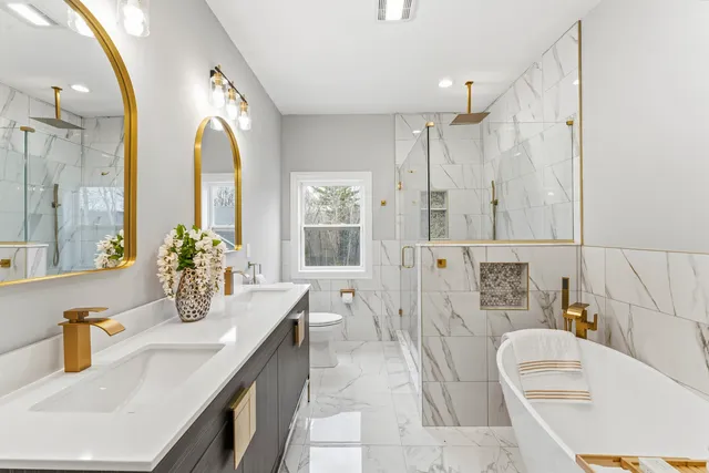 a bathroom with a tub sink and mirror