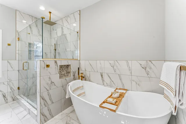 a bathroom with a bathtub and shower