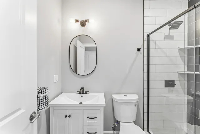 an empty room with windows and ceiling fan