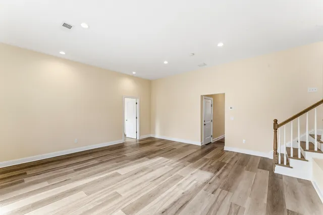 a view of a room with wooden floor