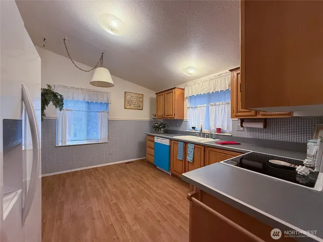 a kitchen that has a sink and a stove in it