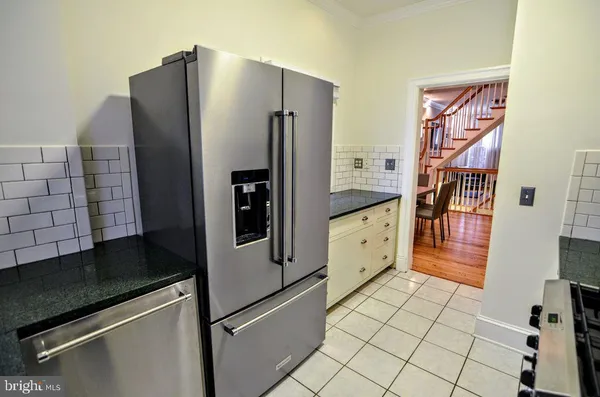 a kitchen with stainless steel appliances a refrigerator and cabinets