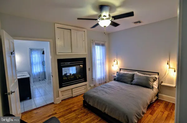 a bedroom with a bed and a fireplace
