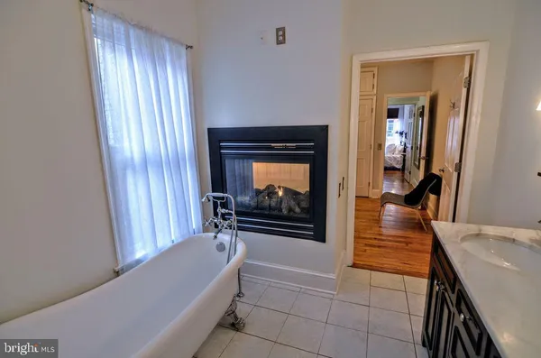 a hallway with a fireplace and a couch