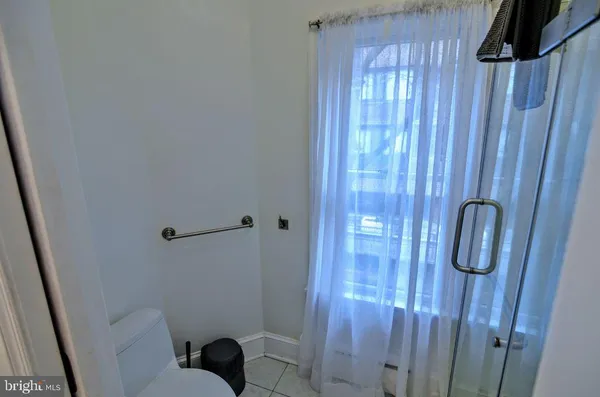 a hallway with a bed and a closet