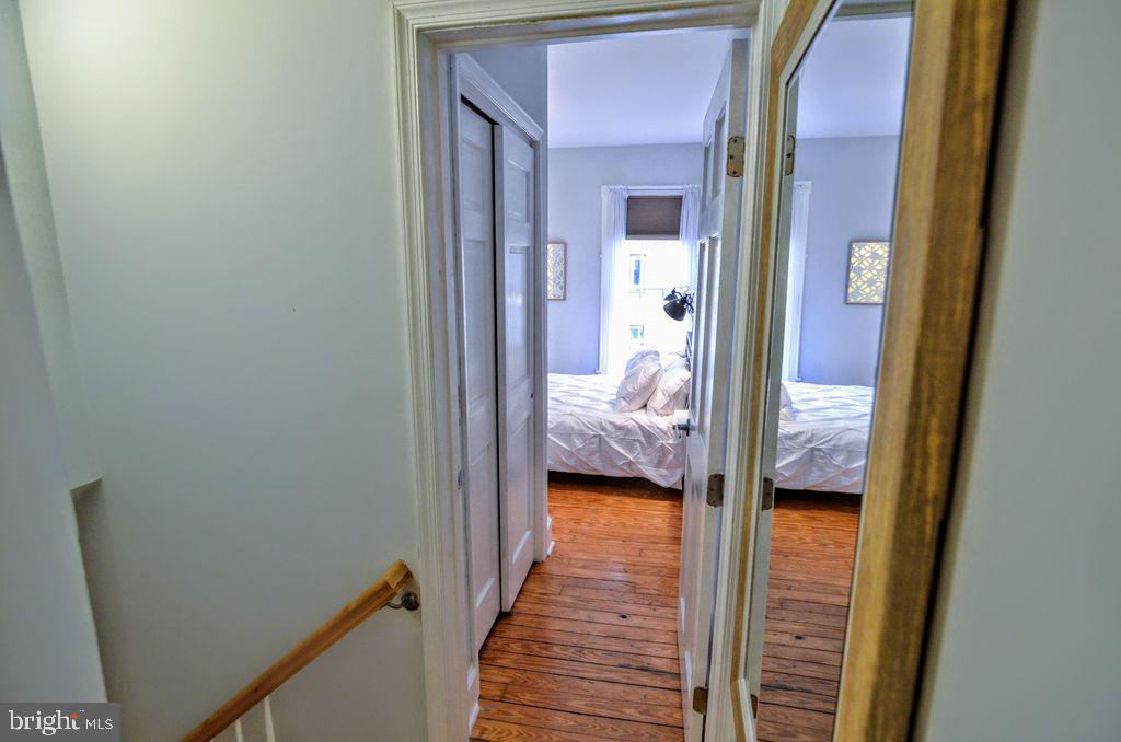 1029 30th Street Northwest Washington, DC 20007 - Photo 19 of 40 a hallway with a bed and a closet