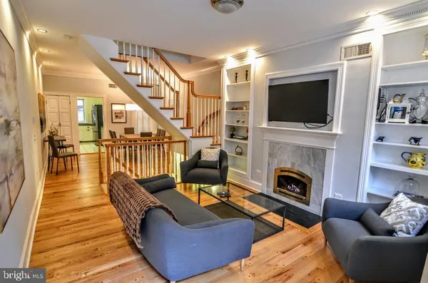 a living room with furniture fireplace and flat screen tv