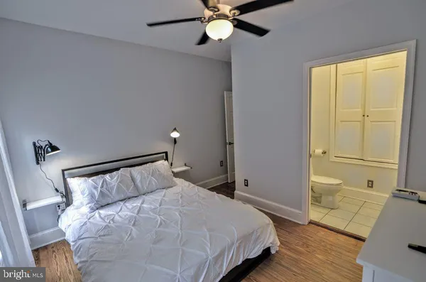a bedroom with a bed and flat screen tv