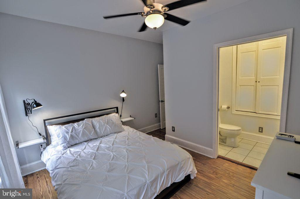 1029 30th Street Northwest Washington, DC 20007 - Photo 22 of 40 a bedroom with a bed and wooden floor