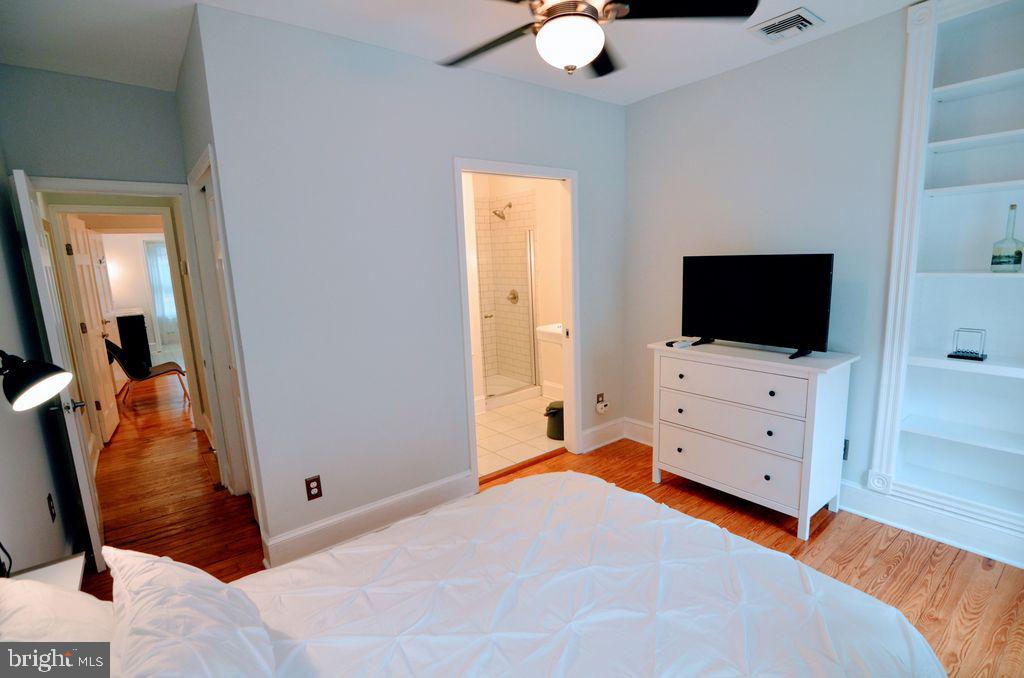1029 30th Street Northwest Washington, DC 20007 - Photo 23 of 40 a bedroom with a bed and flat screen tv