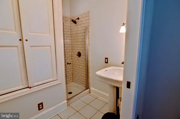 a bedroom with a bed and a sink