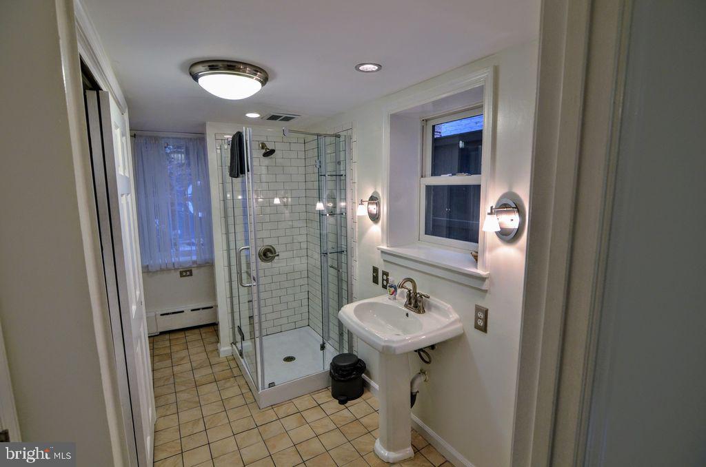 1029 30th Street Northwest Washington, DC 20007 - Photo 26 of 40 a bathroom with a sink shower and a mirror