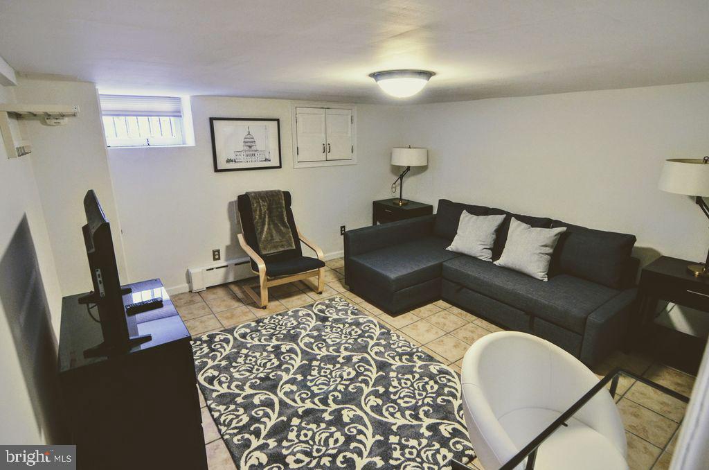 1029 30th Street Northwest Washington, DC 20007 - Photo 28 of 40 a living room with furniture and a chair