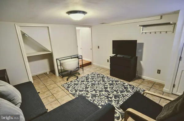 a bedroom with a bed and a rug