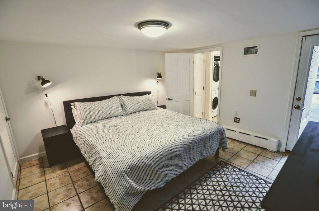 1029 30th Street Northwest Washington, DC 20007 - Photo 30 of 40 a bedroom with a bed and a rug