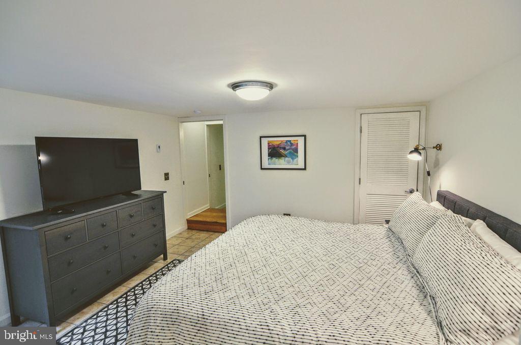 1029 30th Street Northwest Washington, DC 20007 - Photo 31 of 40 a bedroom with a bed and a flat screen tv