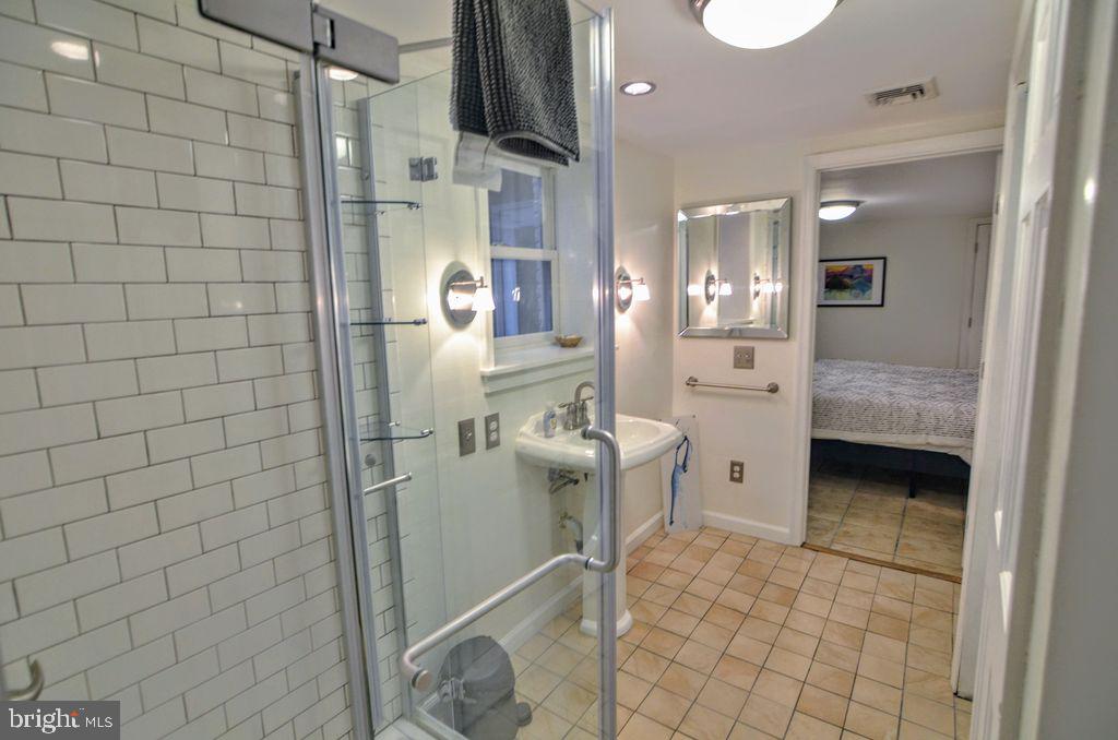 1029 30th Street Northwest Washington, DC 20007 - Photo 33 of 40 a bathroom with a sink a toilet and shower