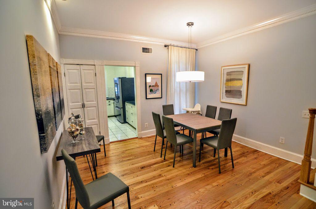 1029 30th Street Northwest Washington, DC 20007 - Photo 6 of 40 a view of a dining room with furniture and wooden floor