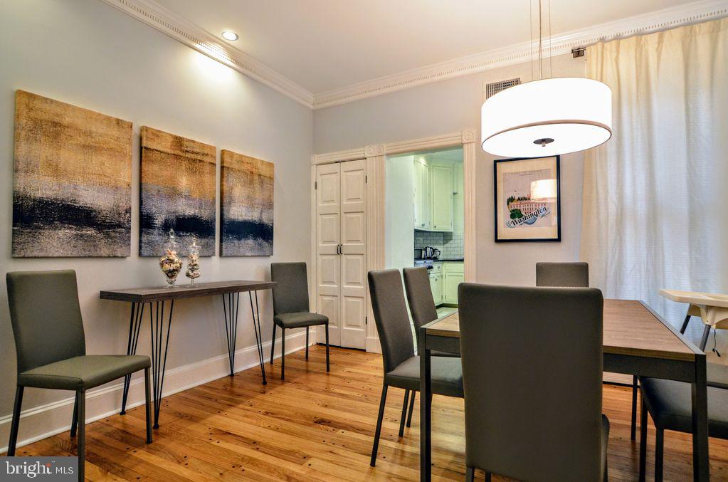 1029 30th Street Northwest Washington, DC 20007 - Photo 7 of 40 a dining room with furniture window and wooden floor