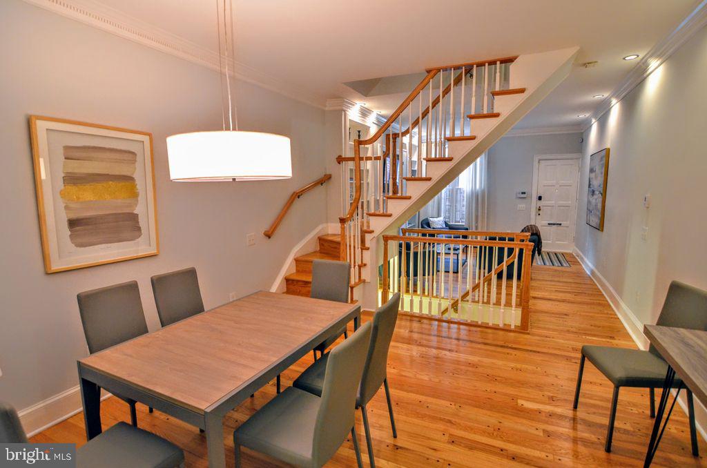 1029 30th Street Northwest Washington, DC 20007 - Photo 8 of 40 a dining room with furniture a rug and wooden floor