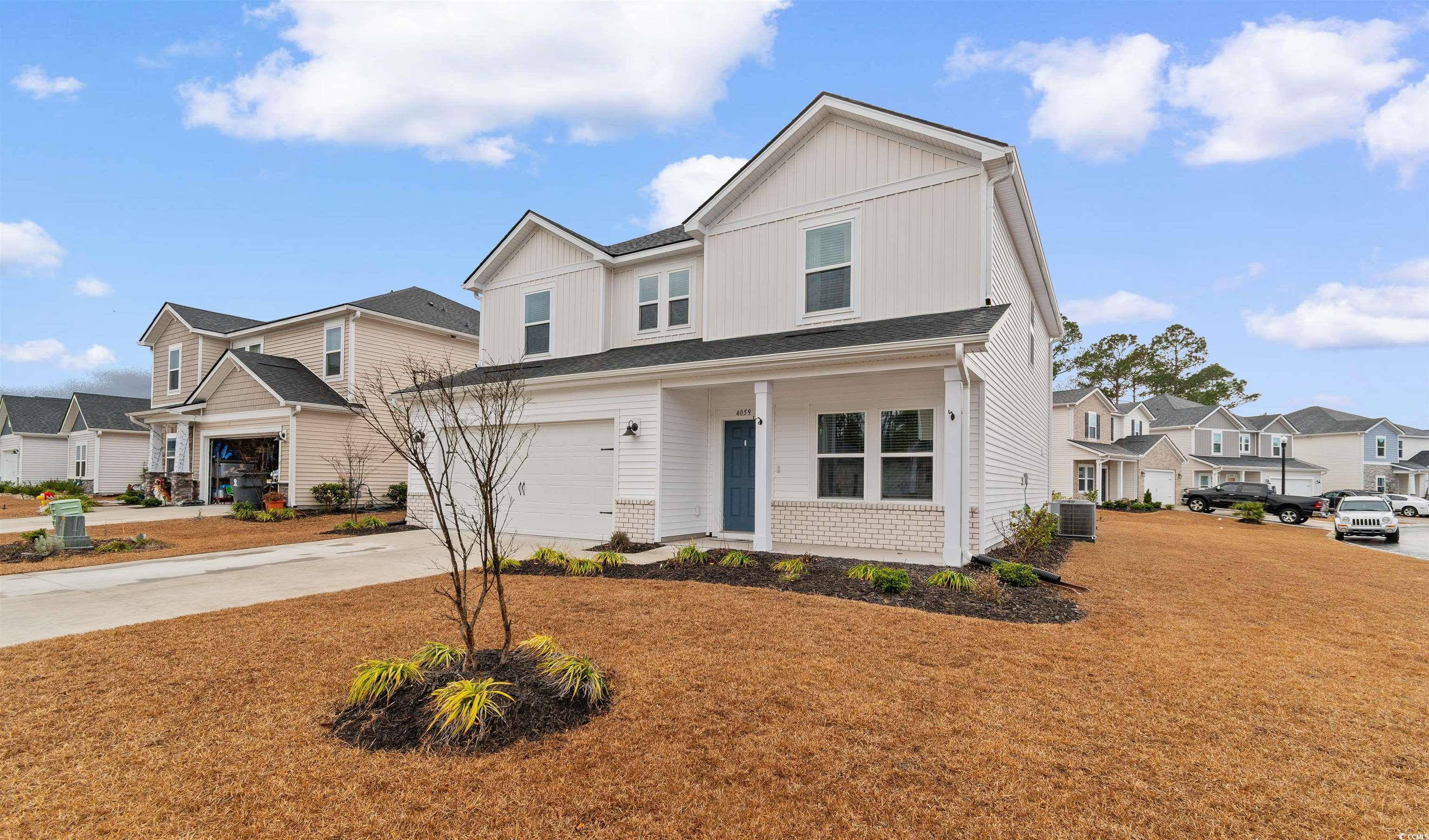 4059 Bayhill Street Myrtle Beach, SC 29579 - Photo 2 of 40 View of front of house with driveway, a residential view, a porch, and board and batten siding