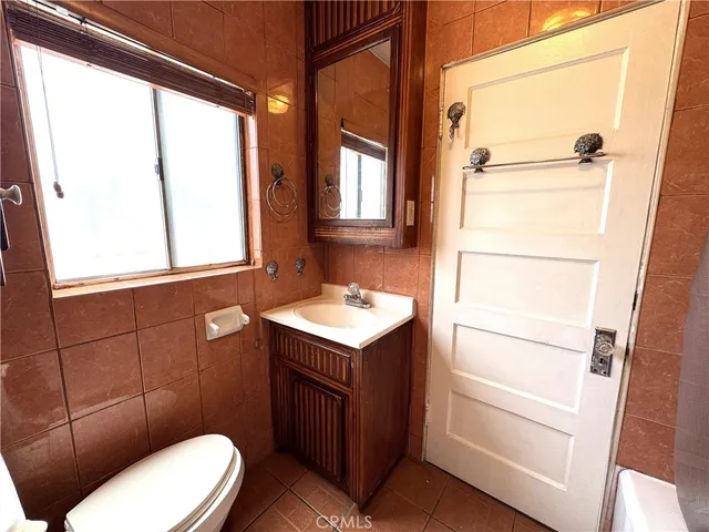 a white toilet sitting next to a bathroom sink