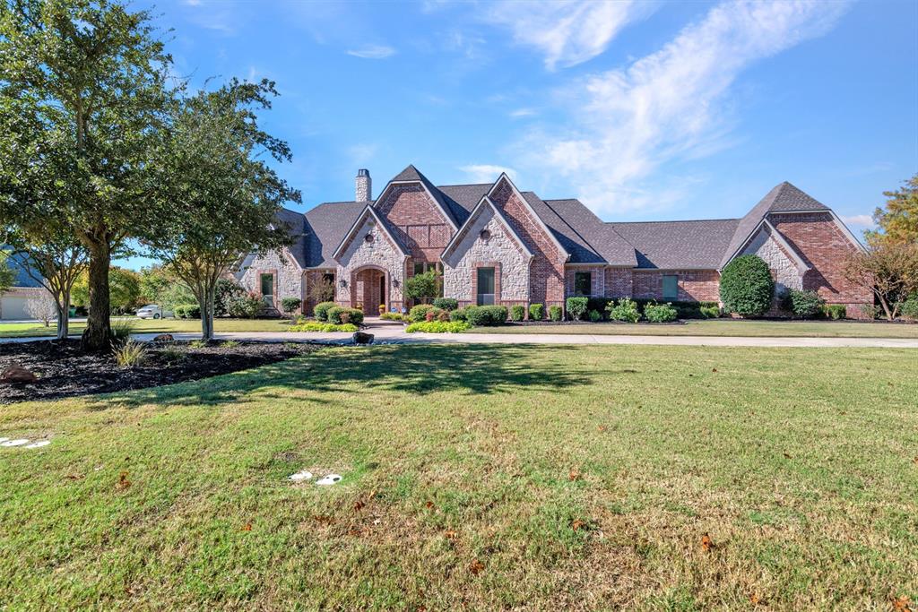 a view of house with garden space and tall trees