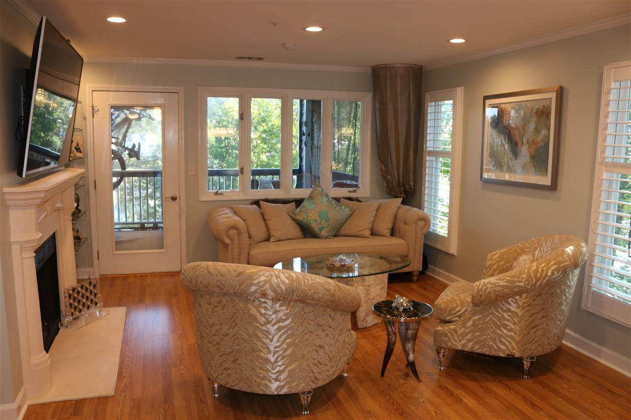 520 Springfork Drive, Unit 520 Cary, NC 27513 - Photo 5 of 25 Large Family Room with Custom Stone Fire Place, Built in Glass Shelving, Cable TV Access, Overlooking Large Lake Large Family Room