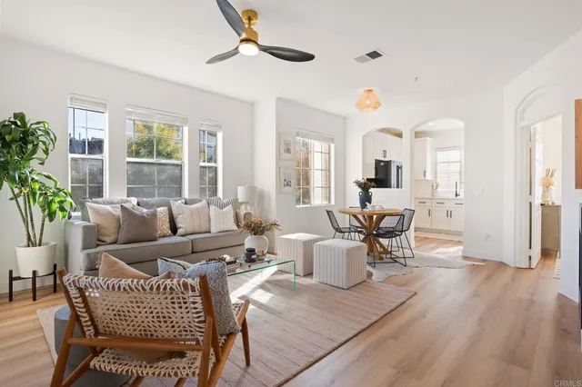 a living room with furniture and wooden floor