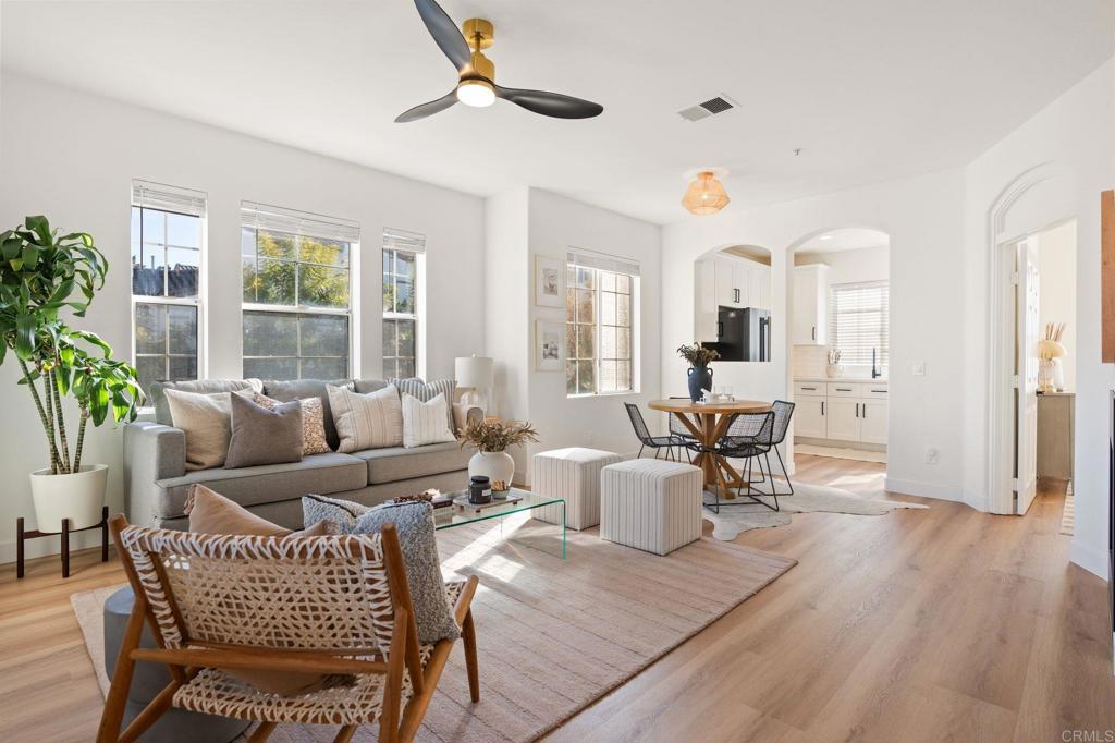 a living room with furniture and wooden floor