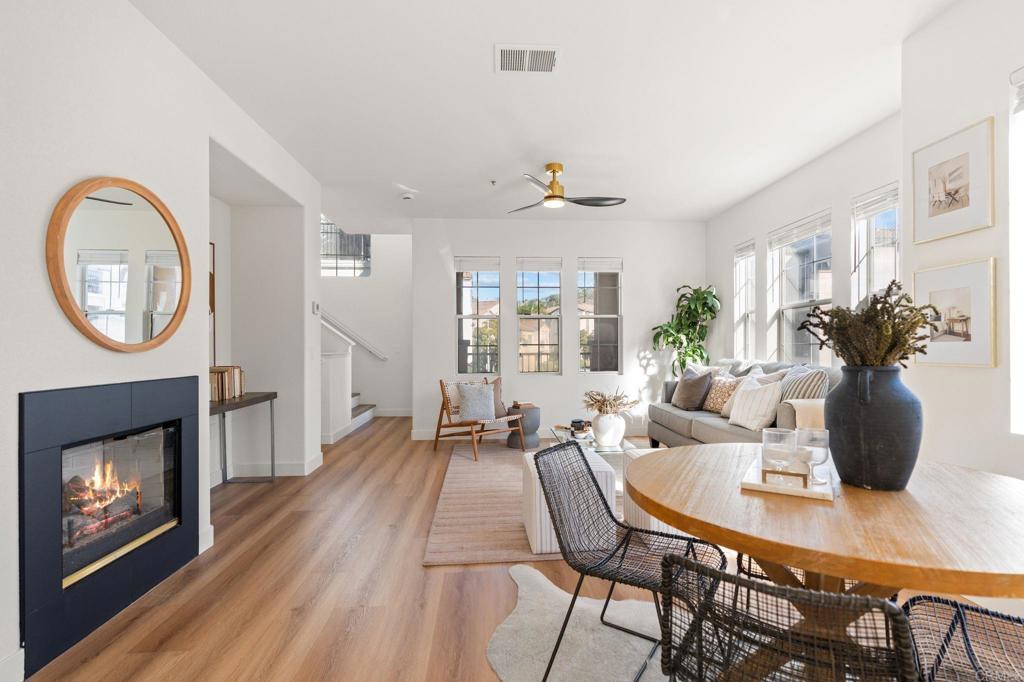3114 Via Puerta Carlsbad, CA 92009 - Photo 12 of 39 a living room with furniture a fireplace and a potted plant