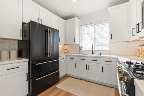a kitchen with stainless steel appliances a refrigerator stove and sink