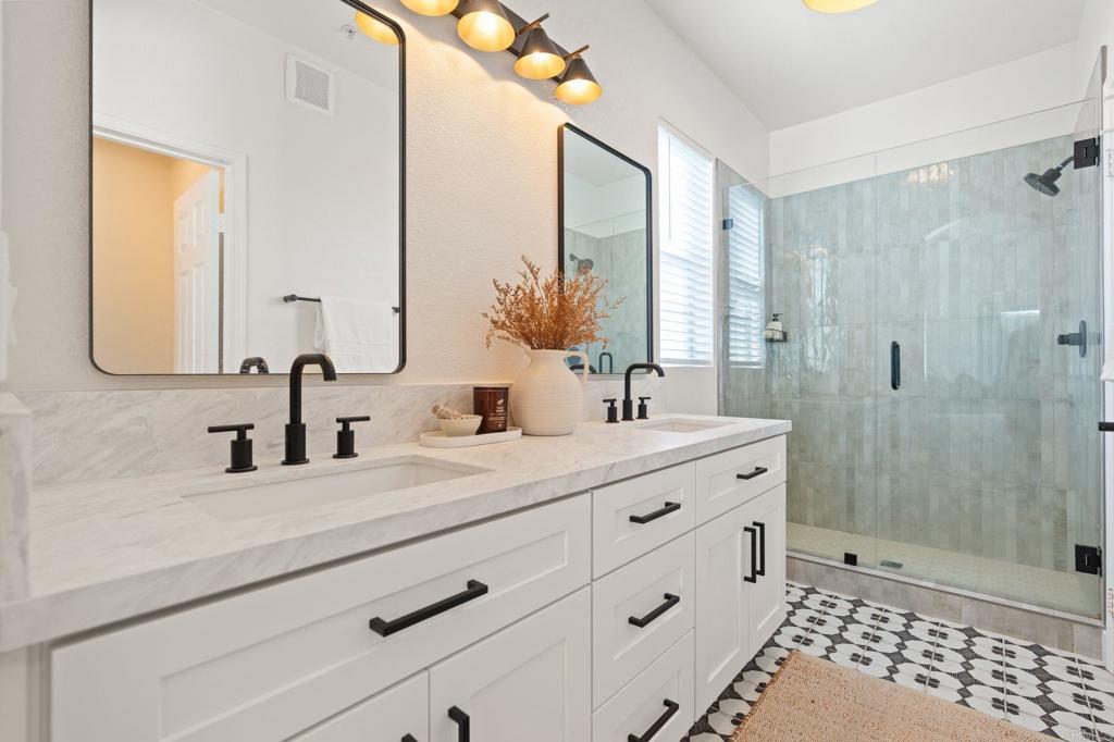 3114 Via Puerta Carlsbad, CA 92009 - Photo 22 of 39 a bathroom with a double vanity sink mirror and shower