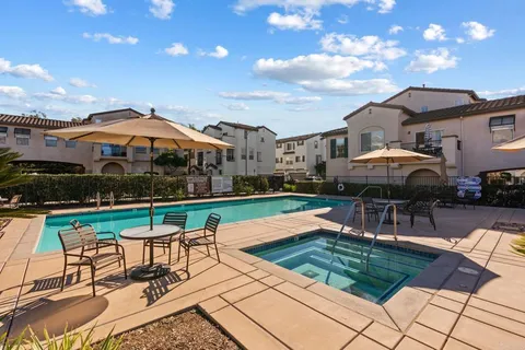 a swimming pool with outdoor seating water slide and yard