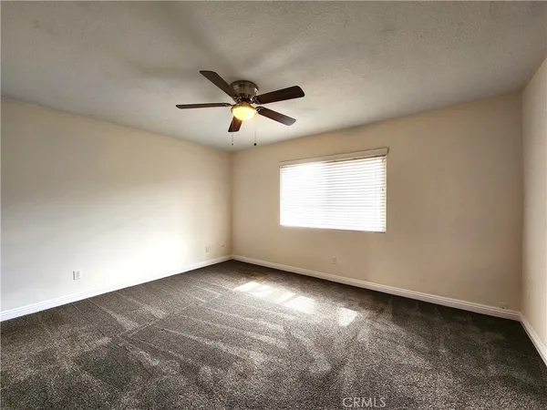 a view of a hallway with wooden floor and closet